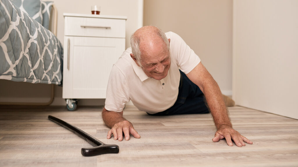 Senior Man Grimacing In Pain After A Fall